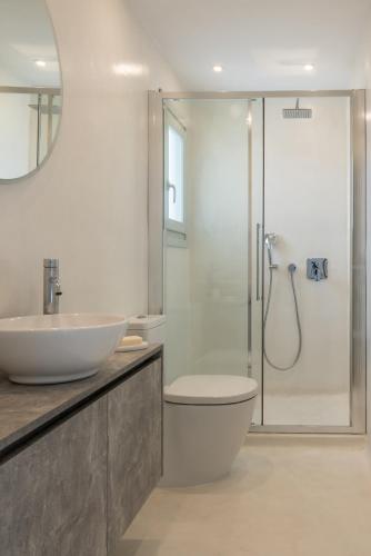 a bathroom with a sink and a toilet and a shower at Nevermind vacations villaB in Kastrianí