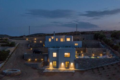 a large white house at night with lights at Nevermind vacations villaB in Kastrianí