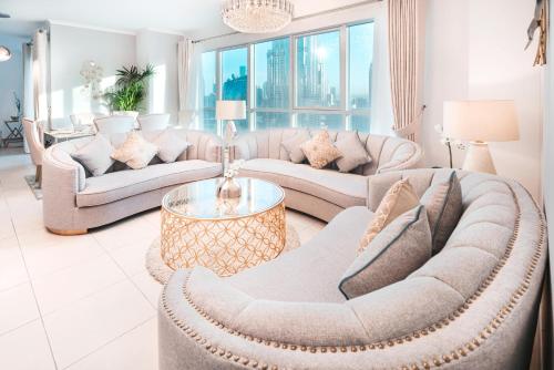 a living room with two couches and a table at Elite Royal Apartment - Full Burj Khalifa & Fountain view - Ambassador in Dubai