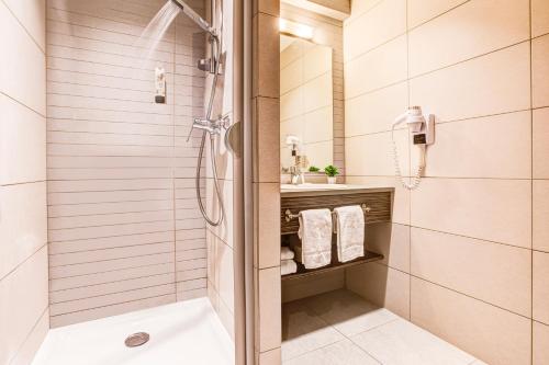 a bathroom with a shower and a sink at Republik Hotel in Lyon