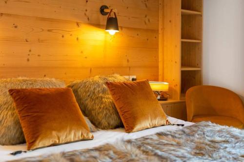 a bed with some pillows on top of it at Les Freinets - Apt B201 - BO Immobilier in Châtel