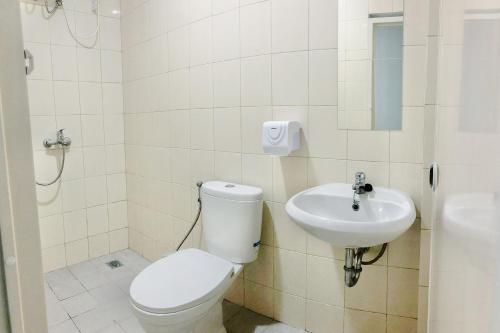 a bathroom with a toilet and a sink at Social Hub by TwoSpaces in Jakarta