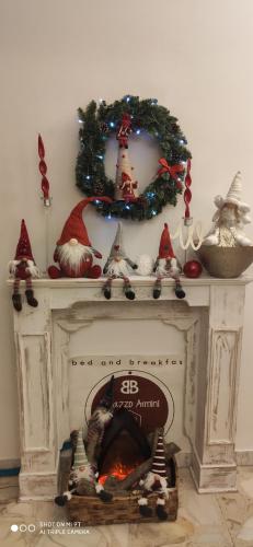 a fireplace with a christmas wreath on top of it at B&B Palazzo Armini in Rogliano