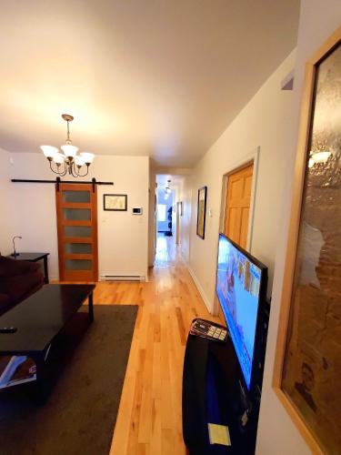 a living room with a flat screen tv in a room at Maison Montplaisir in Montréal