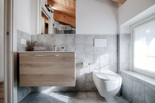 a bathroom with a toilet and a sink and a window at Spazio 77 - The House Of Travelers in Como
