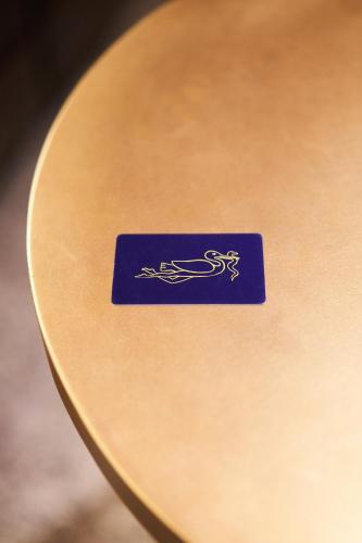 a blue sign on a wooden table at Hôtel du Sentier in Paris