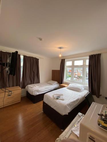 a room with two beds and a window at HS2 Contractors Accommodation in High Wycombe