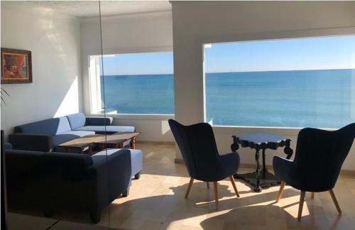 a living room with a couch and chairs and a table at Hotel Boutique Milla de Plata in Torreguadiaro