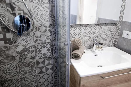 a bathroom with a sink and a shower at Spazio 77 - The House Of Travelers in Como