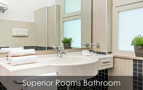 a bathroom with a white sink and a mirror at Hotel Olimpico in Pontecagnano