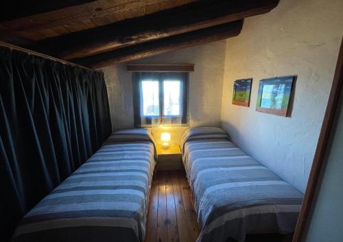 a room with three beds with a window and a lamp at SAN TEODORO PUNTA EST AMPIO TRILOCALE VISTA MARe in Capo Coda Cavallo