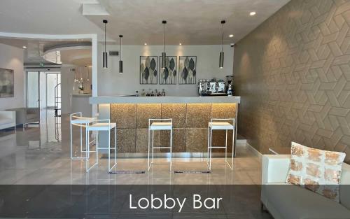 a kitchen with a bar and some stools at Hotel Olimpico in Pontecagnano