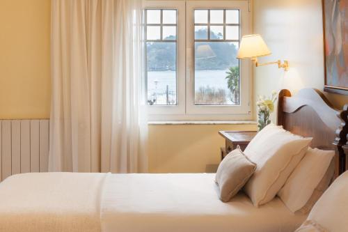 a bedroom with a bed and a window at La Galería in Donostia-San Sebastián
