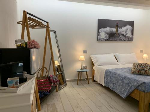 a bedroom with a bed and a tv and a tower at Rosamare in Cesenatico