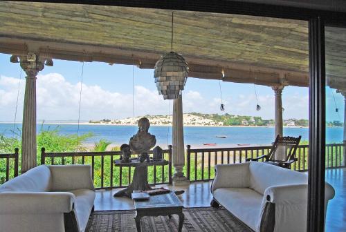a living room with a view of the ocean at The Majlis Resort in Lamu