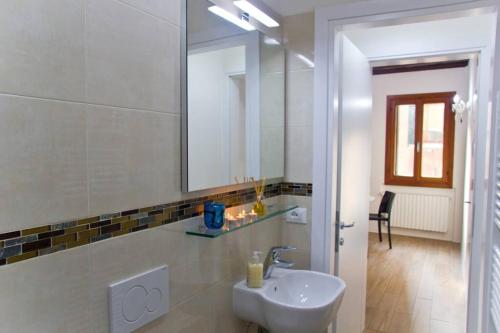 a bathroom with a sink and a mirror at Ca' Venice Canal View in Venice