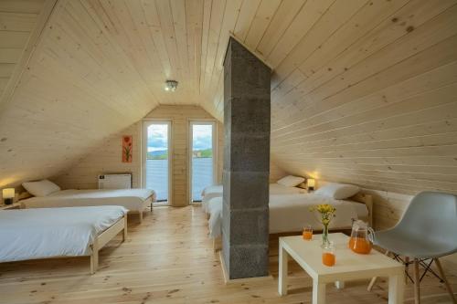 a room with two beds in a attic at Domki Bajeczny Łan in Tylicz