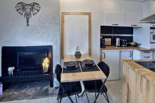 une cuisine avec une table et des chaises ainsi qu'une cheminée dans l'établissement Vue incroyable sur Vannes à deux pas des remparts, à Vannes