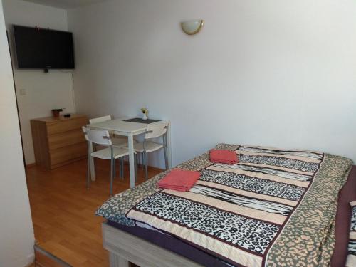 a bedroom with a bed with a table and a tableablish at Apartments U Cara in České Budějovice