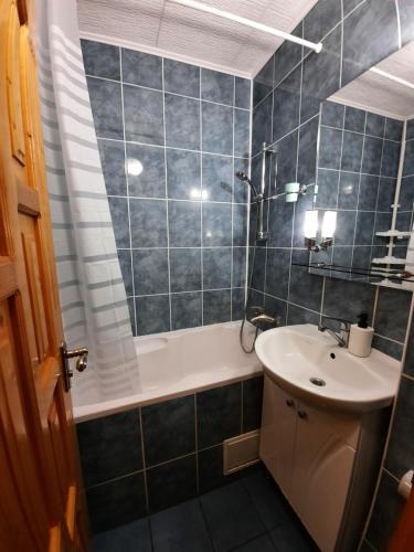 un bagno con un lavandino, una vasca, un water e uno specchio di Двокімнатна квартира біля басейну a Berehove