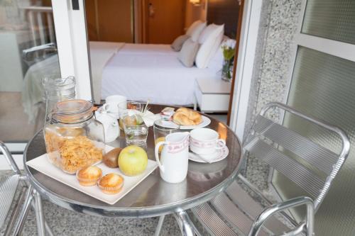 a table with a tray of food on a balcony at Hotel Monte Ulia in Donostia-San Sebastián