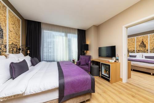a hotel room with a bed and a tv at The Halich Hotel Istanbul Karakoy - Special Category in Istanbul