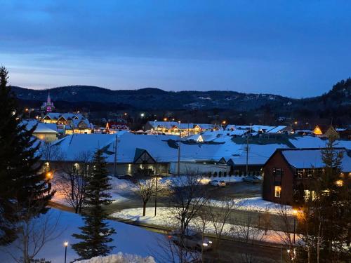 a town covered in snow at night at Hotel and Suites Les Laurentides in Saint-Sauveur-des-Monts
