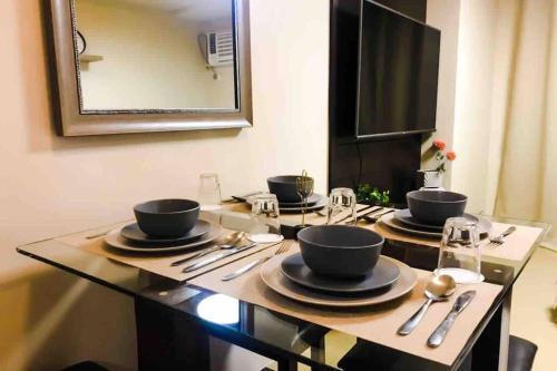 a table with four bowls and spoons on it at Zen Living Condo at Avida Atria Tower 2 in Iloilo City