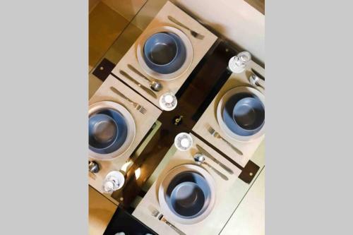 a group of four washing machines in a room at Zen Living Condo at Avida Atria Tower 2 in Iloilo City