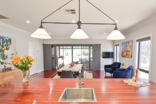 a kitchen and living room with a table and chairs at Indulge Luxury Homes - Dockside Marina in Mildura