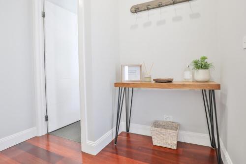 a console table in a room with a white wall at Indulge Luxury Homes - Dockside Marina in Mildura