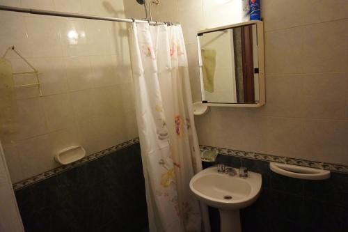 W łazience znajduje się umywalka, toaleta i lustro. w obiekcie Departamentos Kemi w mieście San Luis