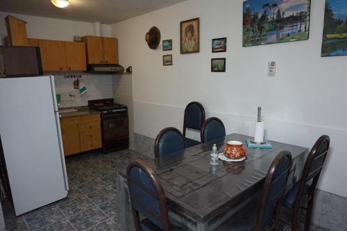 jadalnia ze stołem i krzesłami oraz kuchnia w obiekcie Departamentos Kemi w mieście San Luis