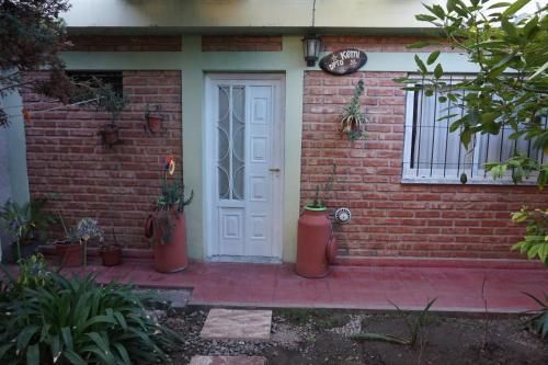 a front door of a brick house with a fire hydrant at Departamentos Kemi in San Luis