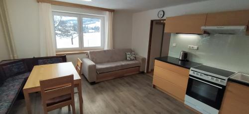 a small living room with a kitchen and a table at U Kapličky in Rokytnice nad Jizerou