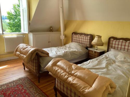 a living room with two beds and a couch at Biscondau in Oloron-Sainte-Marie