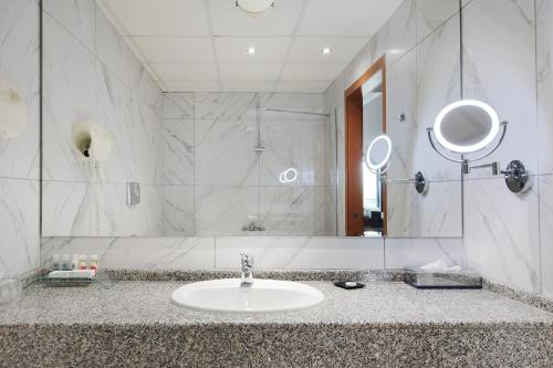 a bathroom with a sink and a mirror at Hotel Z Palace & Congress Center in Xanthi