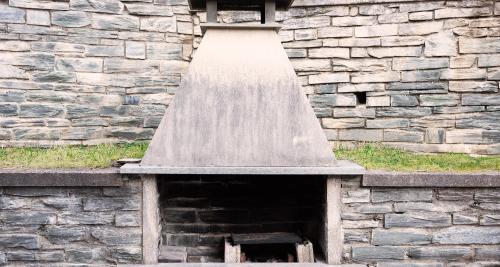 a bird feeder in a stone building with a roof at Lanterna Apartment 1 in Chiesa in Valmalenco