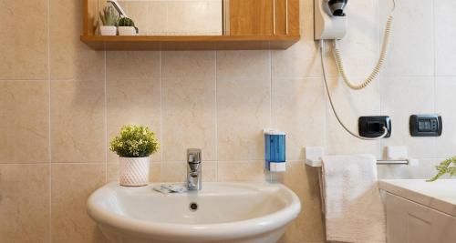 a bathroom with a sink and a toilet at Lanterna Apartment 1 in Chiesa in Valmalenco