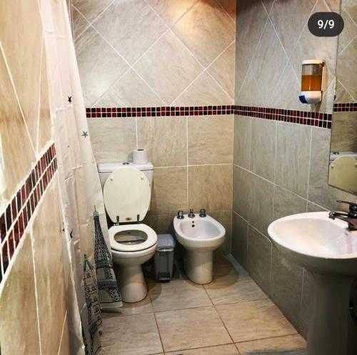 a bathroom with a toilet and a sink at POSADA EN LAS TAPIAS TRANSLASIERRAS in Las Tapias