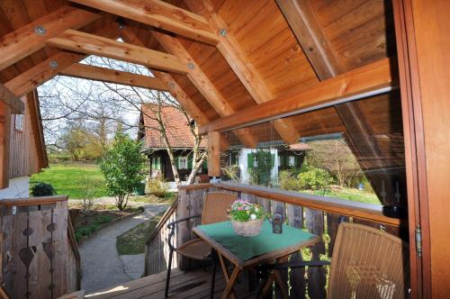 a wooden patio with a table and chairs on a deck at Altes Gehöft am Lormanberg in Kirchberg an der Raab