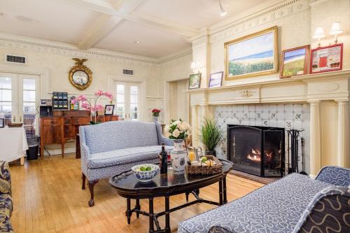 a living room filled with furniture and a fire place at Simsbury 1820 House in Simsbury