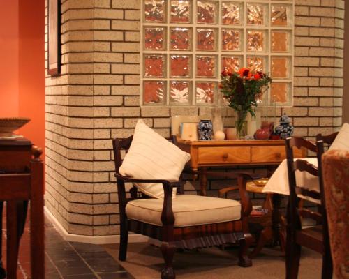 a dining room with a table and chairs and a table and chairs at Melkbosstrand Bed and Breakfast in Melkbosstrand