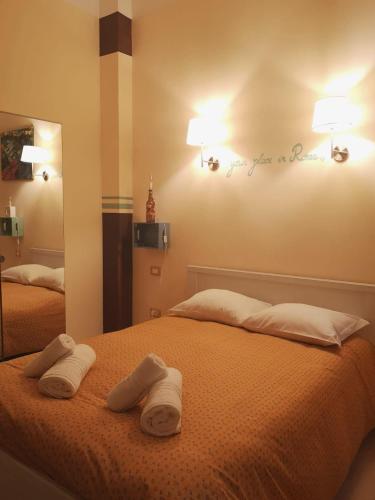 a bedroom with two white towels on a bed at Relais Villa Fiorelli in Rome