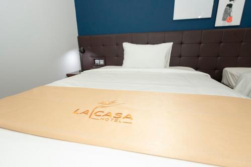 a bed with a la casa hotel sign on it at La Casa Tuy Hòa in Tuy Hoa