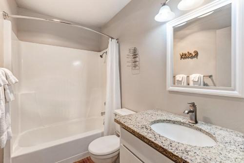 a bathroom with a sink and a toilet and a shower at Bend Riverside Condos Near Downtown Bend in Bend