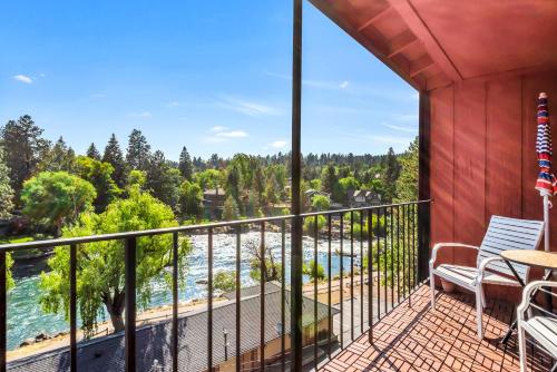 a balcony with a view of the water at Bend Riverside Condos Near Downtown Bend in Bend