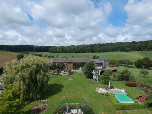 an aerial view of a house with a pool in a yard at Hoeve Espewey - Studio 