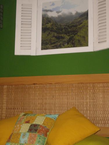 a bedroom with a window and a bed with a quilt at Kira's Boutique Hotel in Mindelo