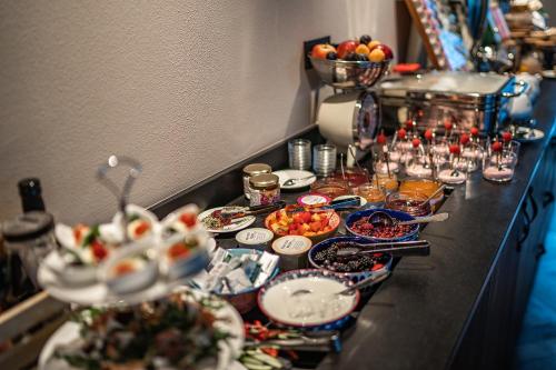 a buffet with plates of food on a table at Prunner Luxury Suites - Adults Only in Schenna